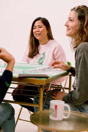 Youmahj apparel and a mug at a mahjong game night