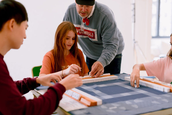 Players building the wall during American Mahjong