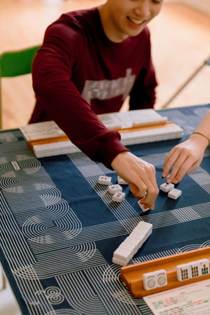 Mahjong tiles laid out on a game cloth