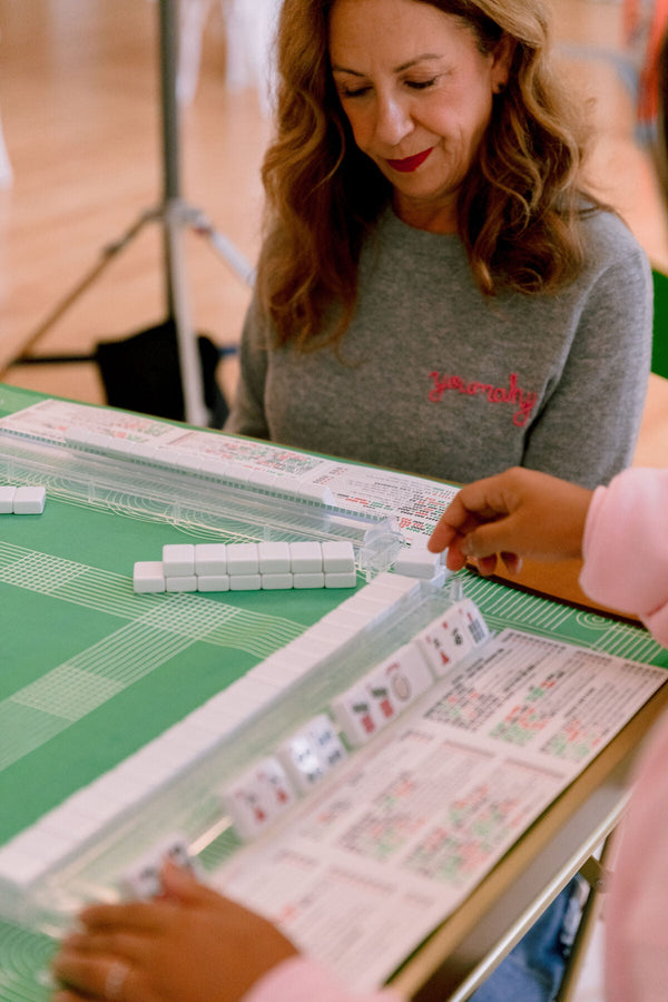 A player reading the National Mah Jongg League card