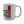White mug with green and red text on a white background