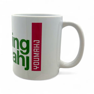 White mug with green and red text on a white background