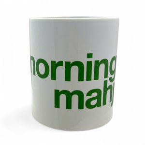White mug with green text 'morning mahi' on a white background