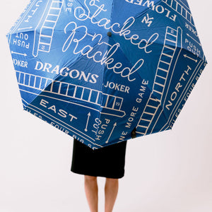 Blue game-themed umbrella with text and graphics on a white background
