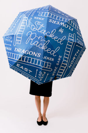 Blue game-themed umbrella with text and graphics on a white background